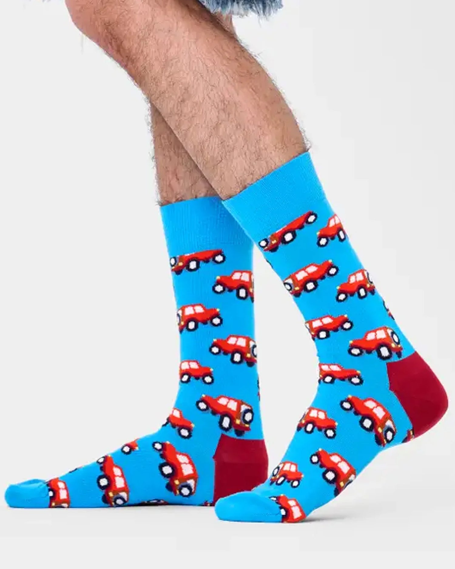 Man wearing sky blue socks with a red car pattern
