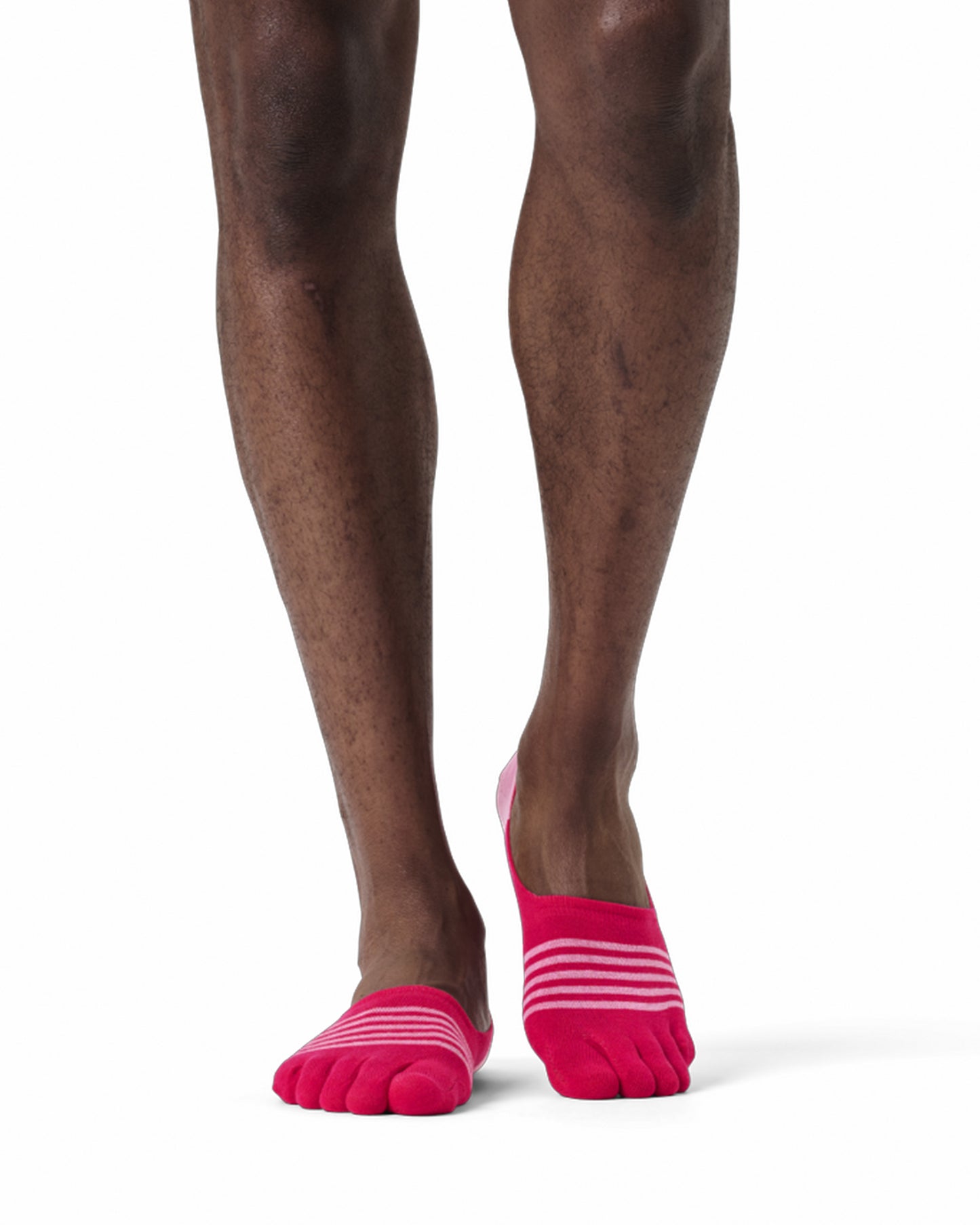 Person wearing pink toe-separated socks on a white background