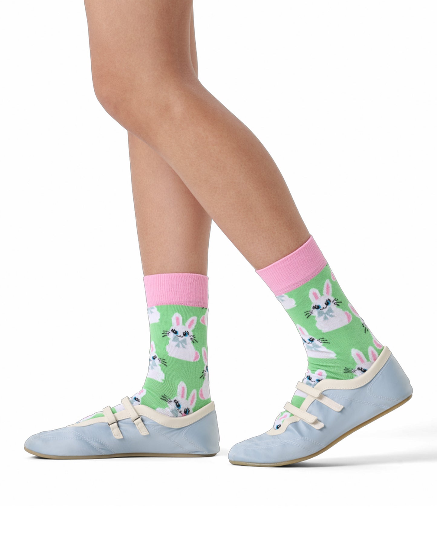 Green socks with bunny design worn by a person on a white background