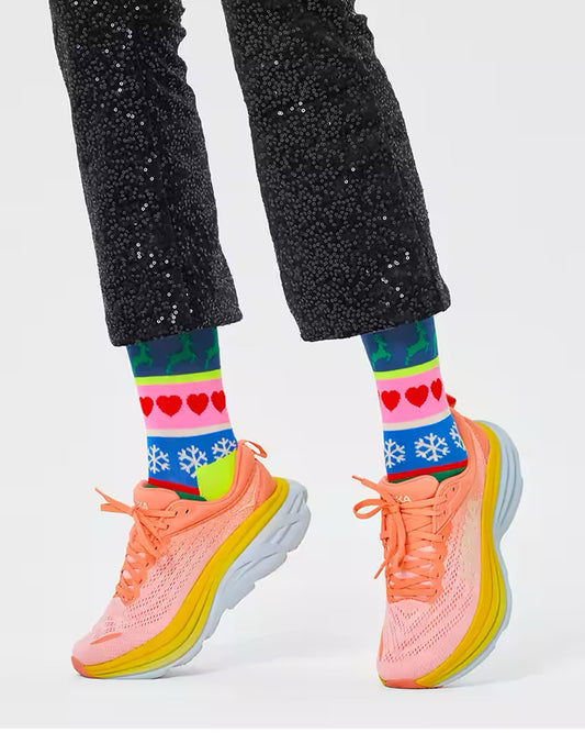 Happy Sock P000265 Christmas Stripe Sock - colourful novelty Xmas socks with snowflakes, reindeer, hearts and Xmas trees. Worn with black sequenced cropped pants and trainers.