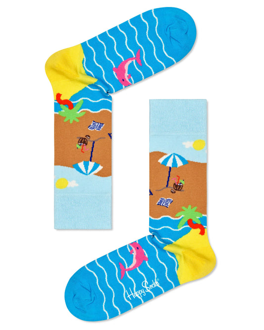 Happy Socks BCH01-0200 Beach Break Socks - Multicoloured Summer seaside themed crew length ankle socks featuring sun, sand and sea along with a deck chair, cocktail, sunscreen and every other beach essential. Pink dolphins and palm trees also feature on this beach scene.
