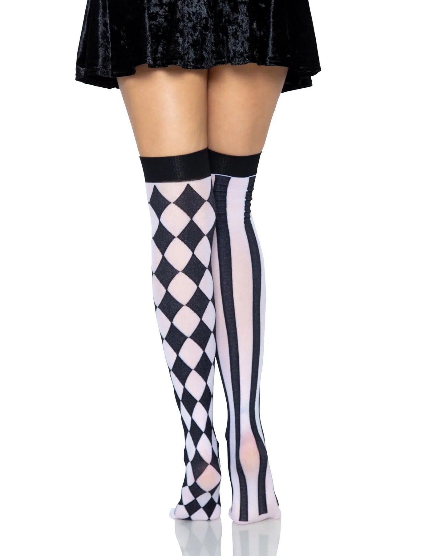 Harlequin and striped thigh-high socks worn with a black skirt on a white background
