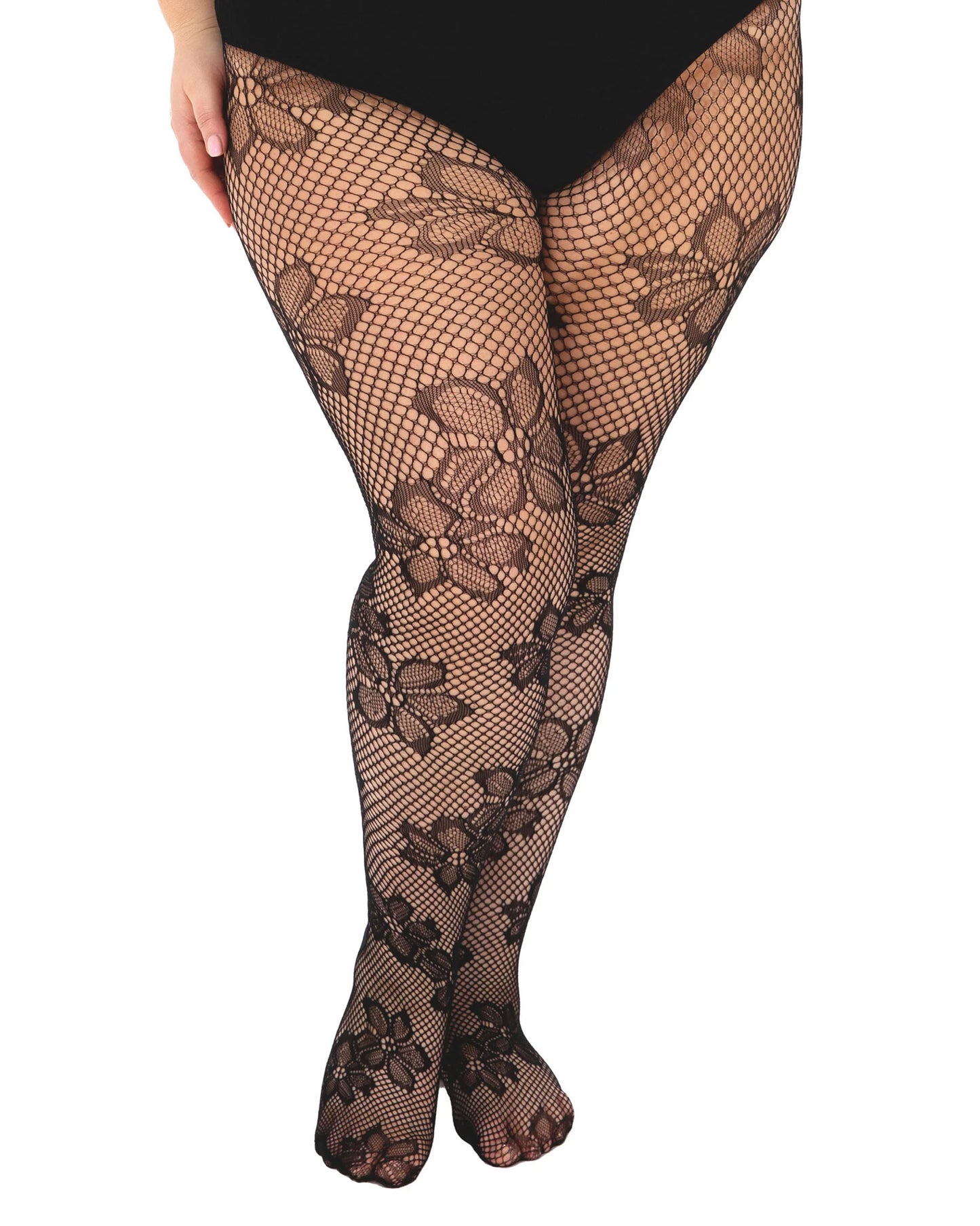 Black fishnet stockings with floral patterns on a white background