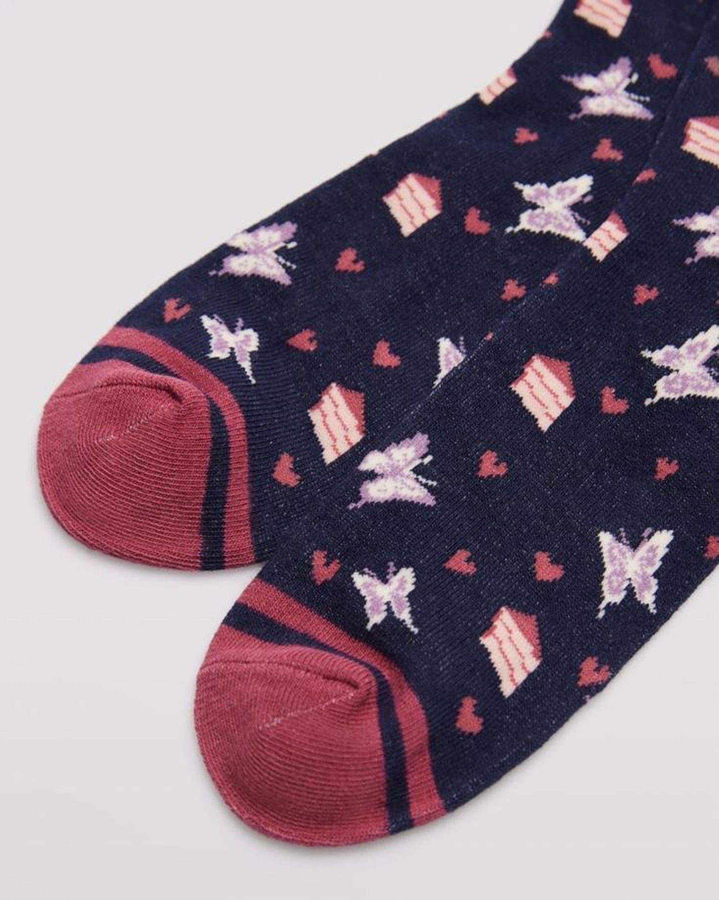 Ysabel Mora 12212 Butterfly & Cake Socks - Navy crew length cotton ankle socks with an all over pattern of butterflies, slices of cake and hearts with a dark dirty pink flat toe seam.