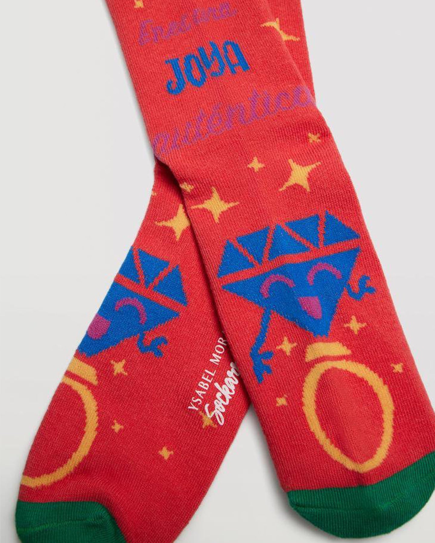 Ysabel Mora Sockarrats - Bright red cotton crew length socks with a multicoloured diamond ring pattern around the cuff, smiling diamond ring motif on the foot and stars, green cuff, toe and heel.