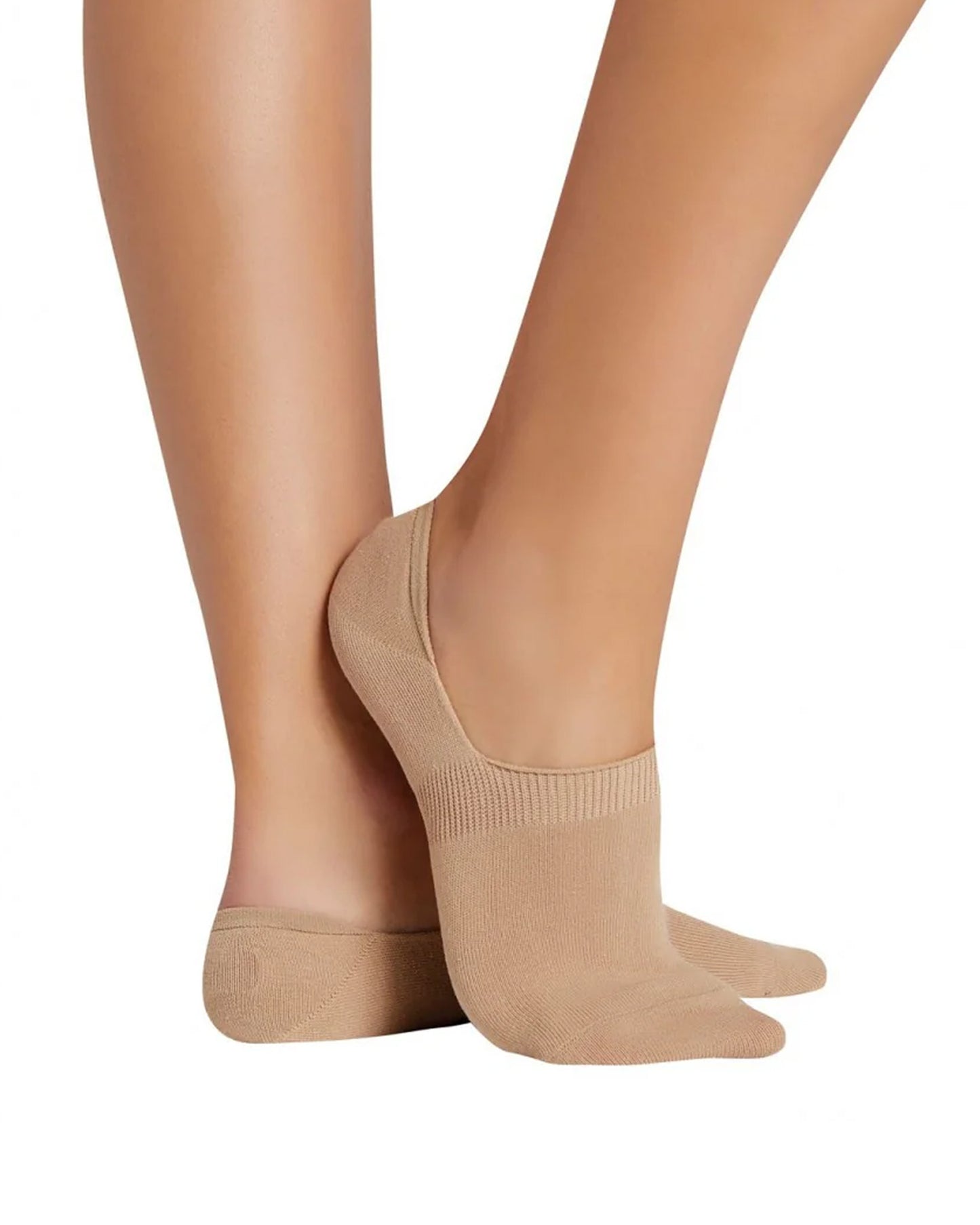Beige low ankle socks worn on a white background
