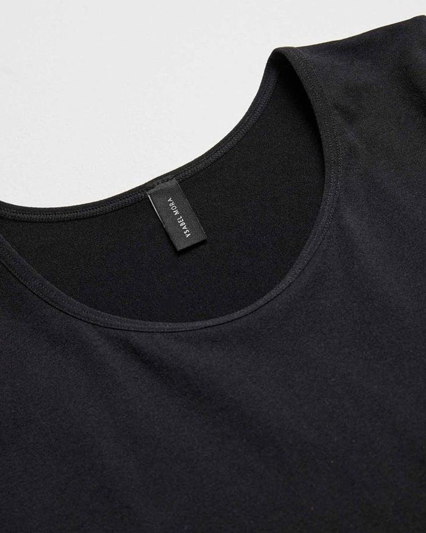 Ysabel Mora Long Sleeve Top - Black soft and stretchy microfibre top with round neck and long sleeves, close up view of crew neck.