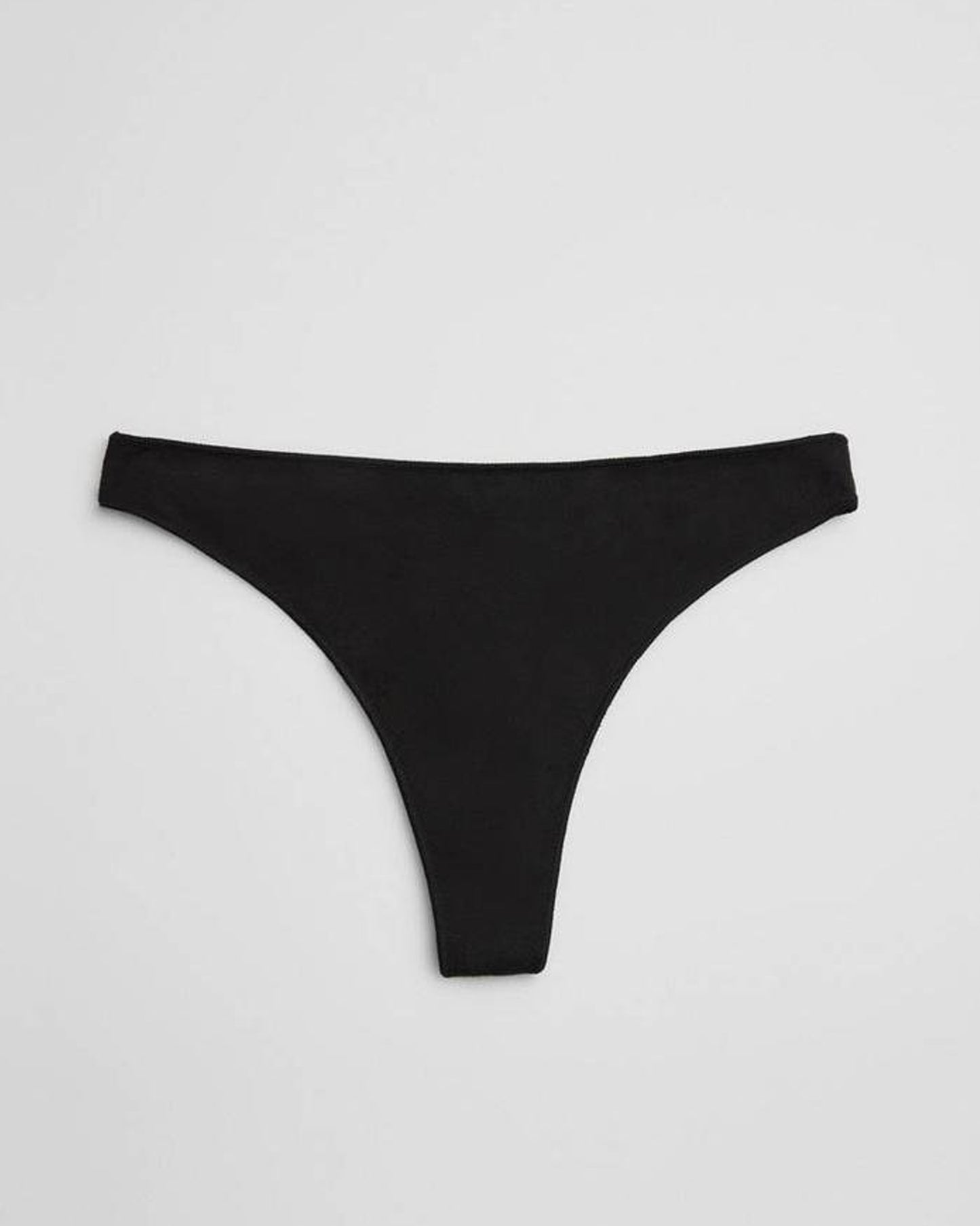 Black thong underwear on a light grey background