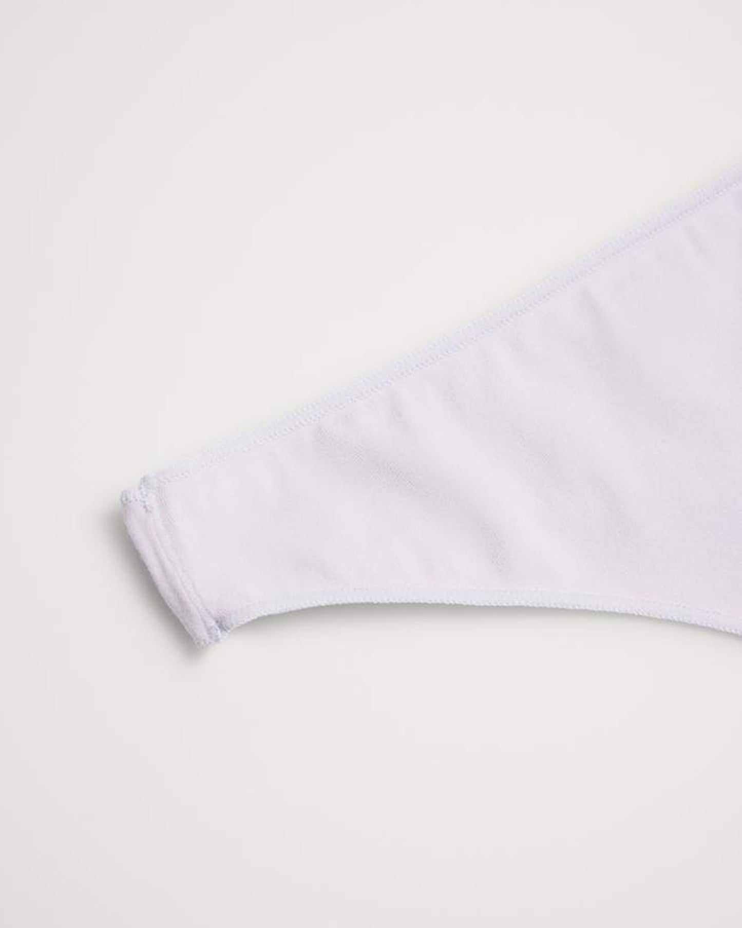 White thong underwear on a light grey background