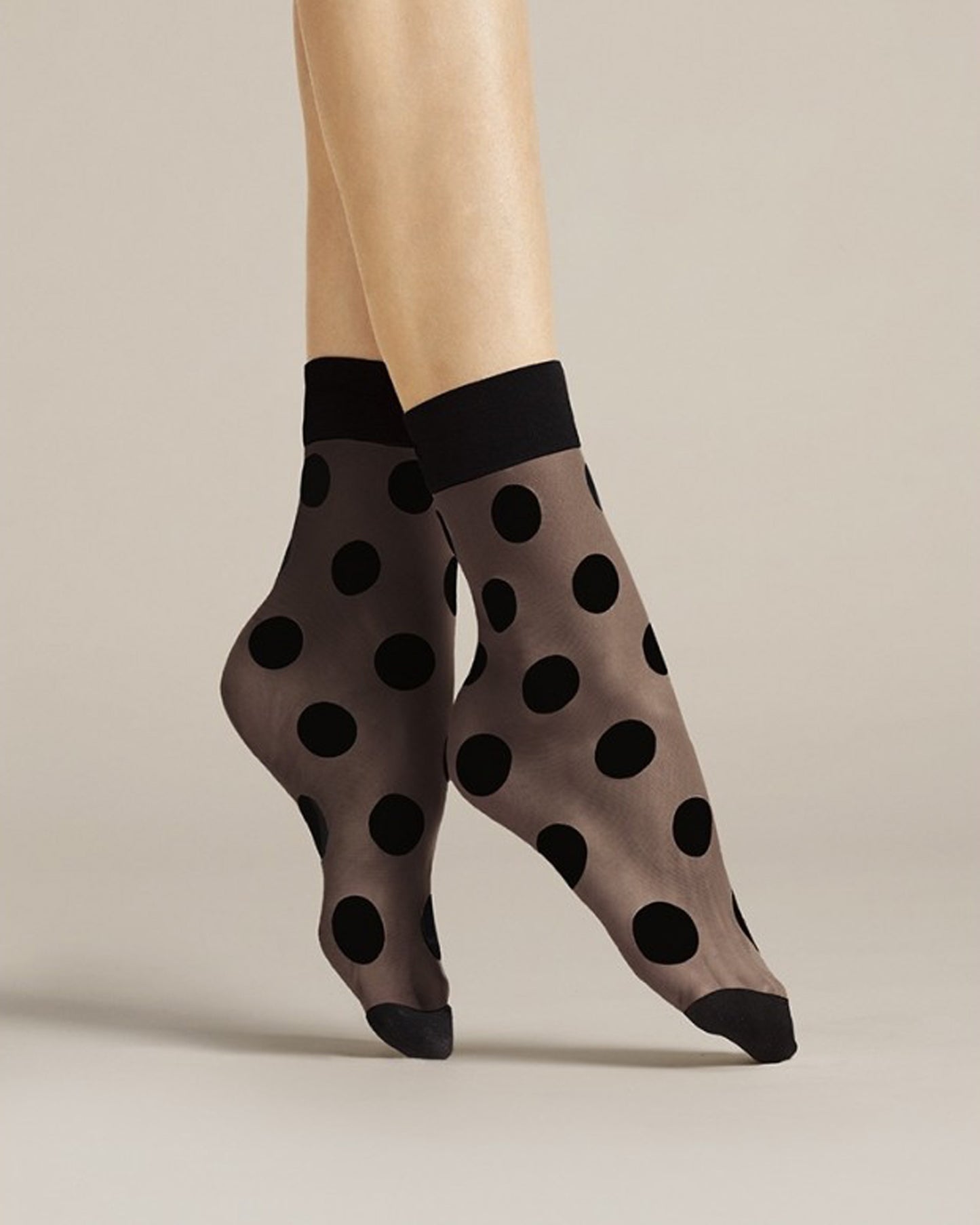 Fiore Virginia Socks - Sheer black fashion ankle socks with a woven opaque polka dot pattern, plain deep cuff and opaque toe. Side view.