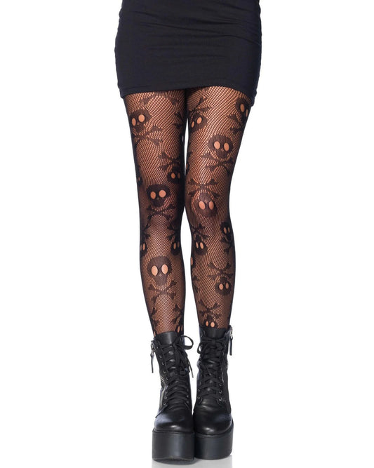 Black fishnet tights with a skull and crossbones pattern, shown on a model's legs paired with a black mini skirt and black platform ankle boots against a white background.