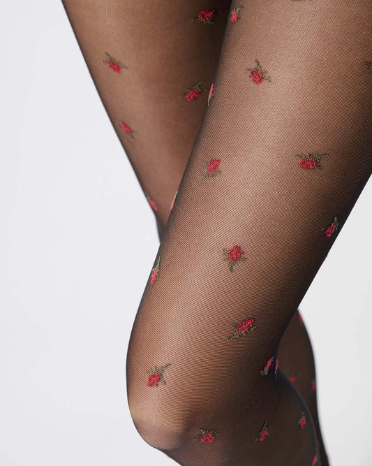Sheer black fashion tights with red roses pattern, close up detail.