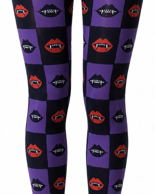Close up of black and purple checkered print Halloween tights with vampire mouths with fangs