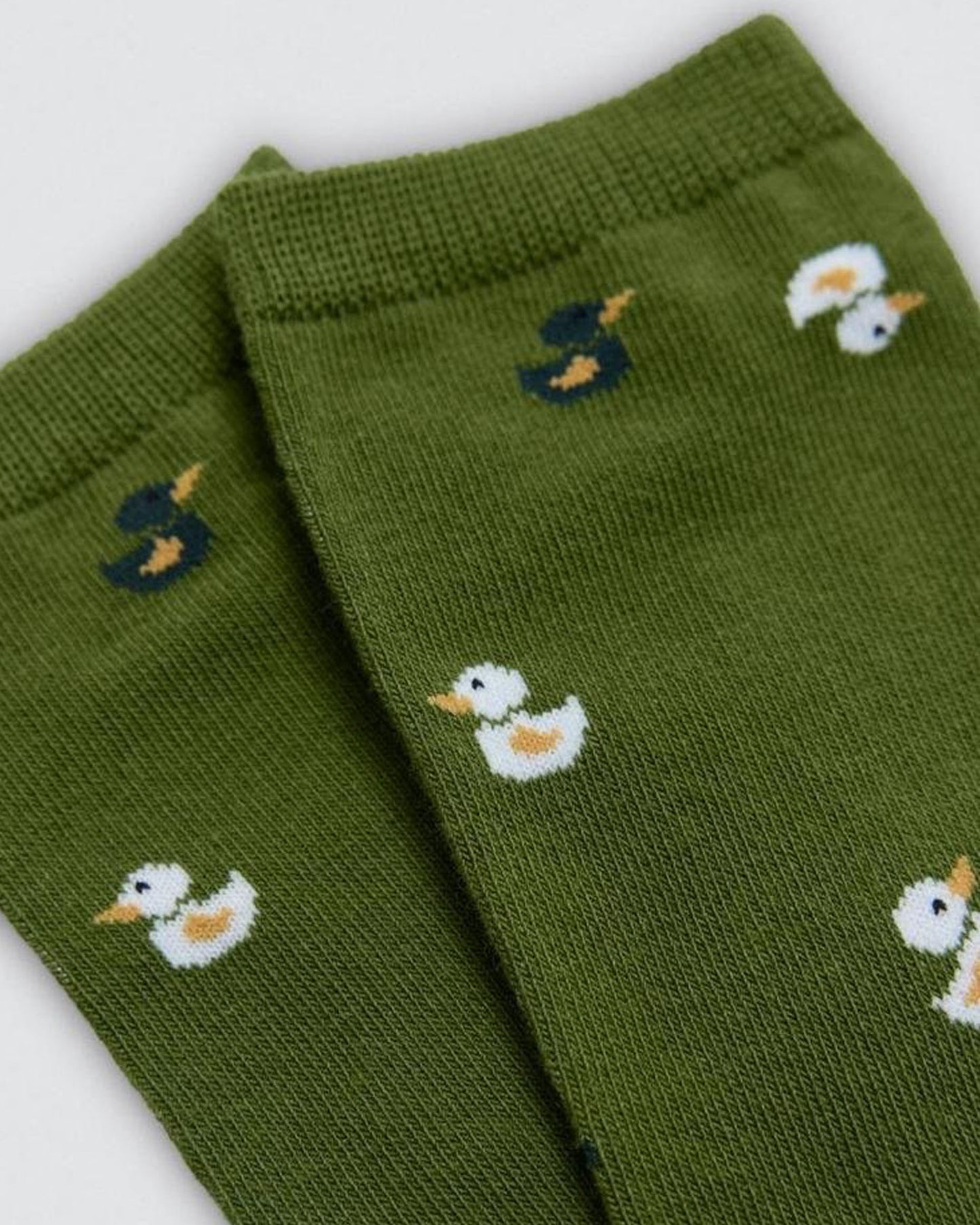 Green socks with duck pattern on a white background