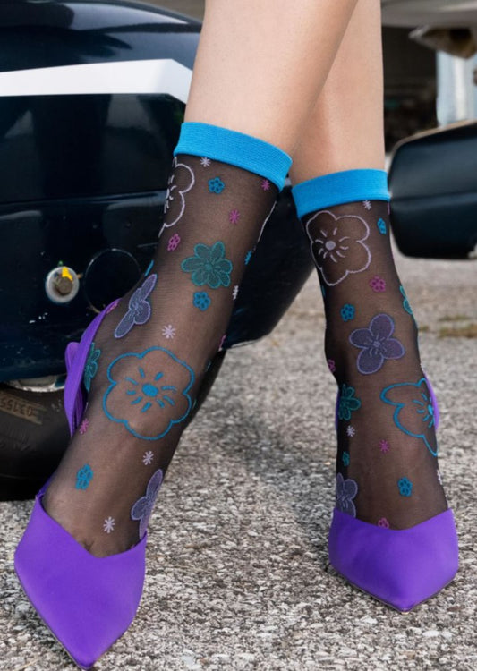 Sheer fashion ankle socks with an all over multicoloured fun floral pattern in shades of blue, purple and pink and plain blue cuff.