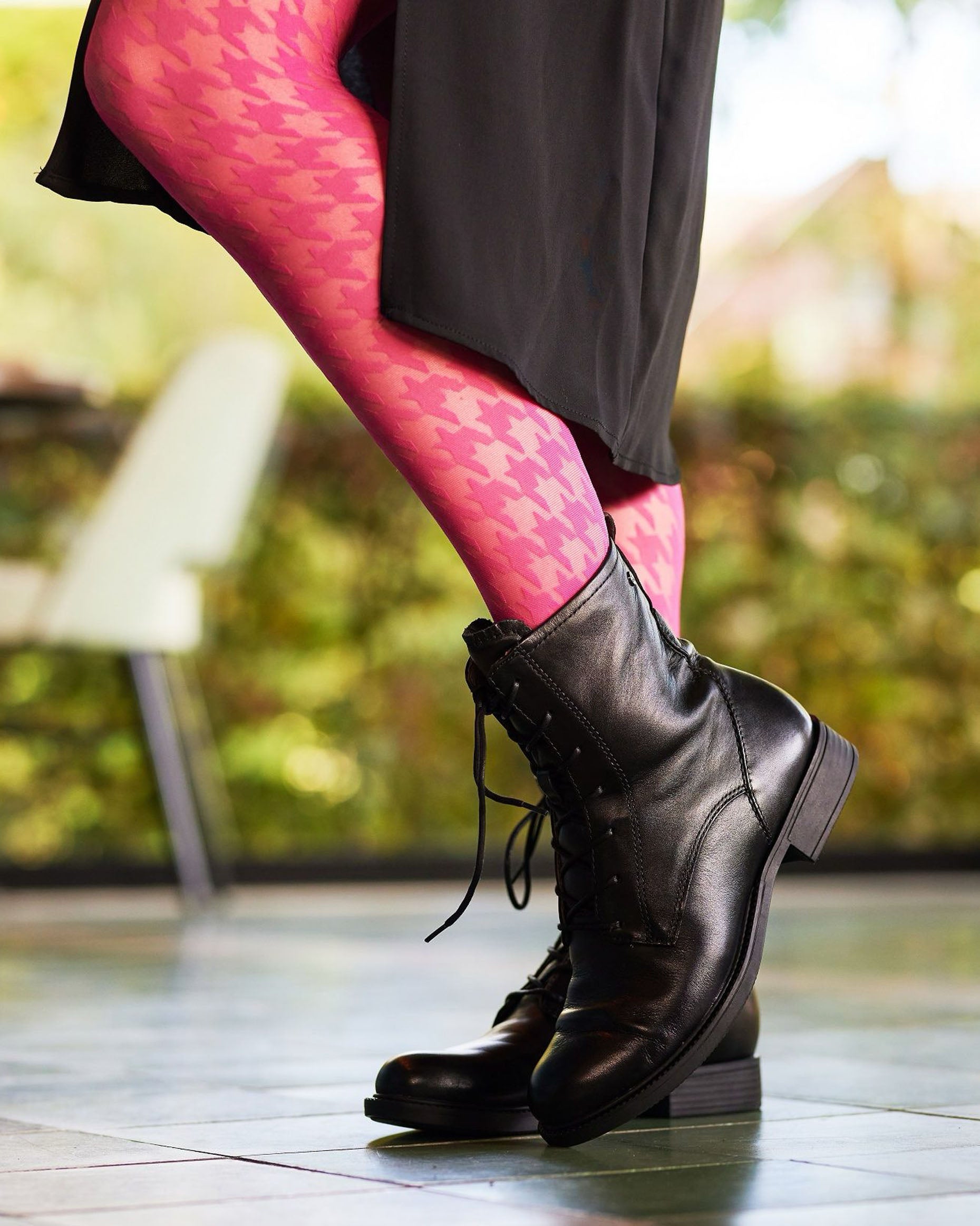 Bonnie Doon BP221903 Houndstooth Tights - Sheer fashion tights with a woven opaque dogtooth pattern in bright pink. Worn with black boots and skirt.