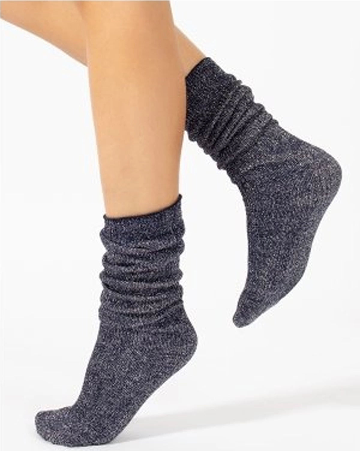 A pair of sparkly navy scrunch socks worn on a person's feet, shown against a plain white background.