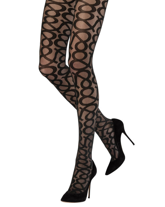 Sheer black fashion tights with an all over opaque & graphic pattern, worn with black high heel stilettos.