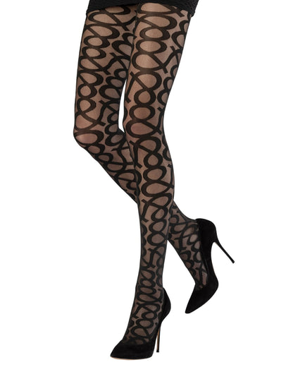 Sheer black fashion tights with an all over opaque & graphic pattern, worn with black high heels and mini skirt.