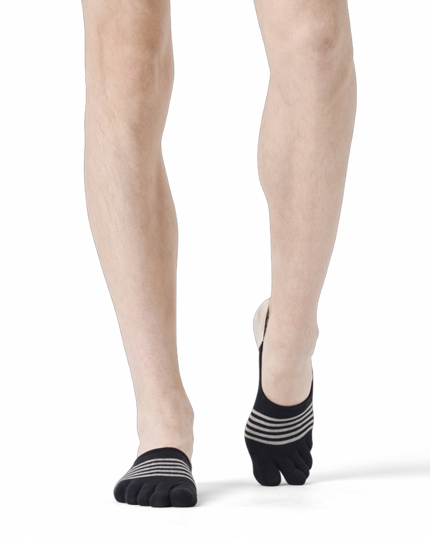 Person wearing black and white striped socks on a white background