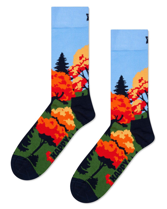 Colourful socks with Autumn trees/forest design with a light blue sky on a white background