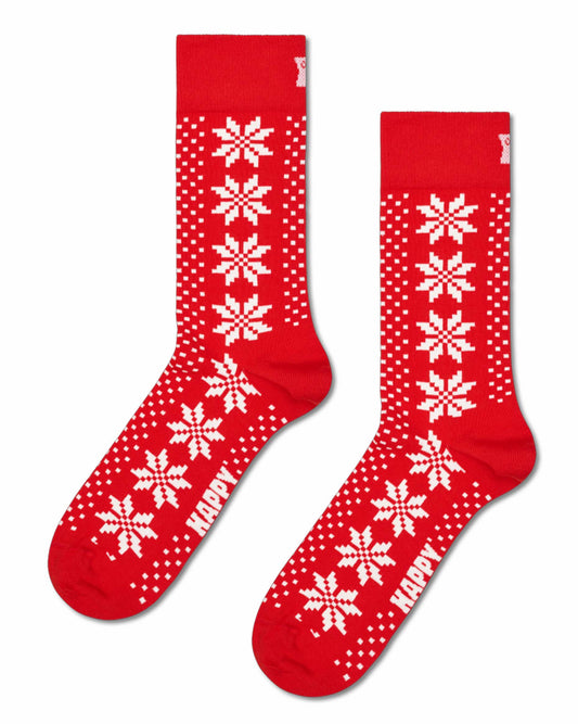 A pair of red crew socks with white knit snowflake and polka dot patterns, featuring the word 'HAPPY' in white on the toes, shown against a plain white background.