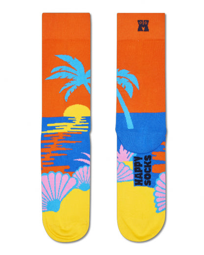 Colorful sock with palm tree and sunset design on an orange background