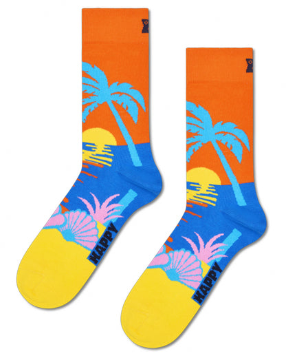 Colorful socks with palm tree and sunset design on an orange background