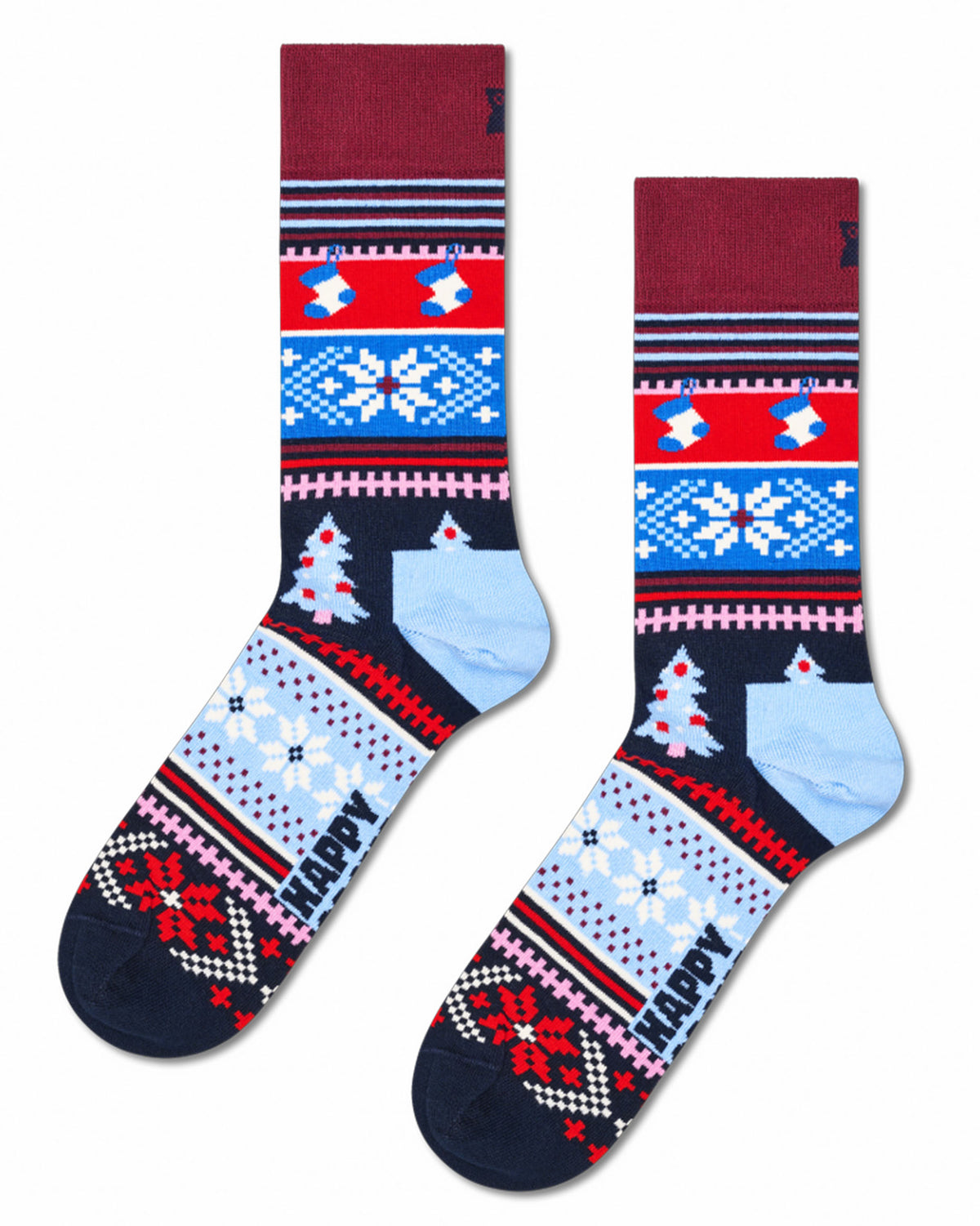 A pair of crew-length Christmas socks with a festive fair isle pattern in red, blue, white, and navy, featuring a light blue heel and toe, on a plain white background.