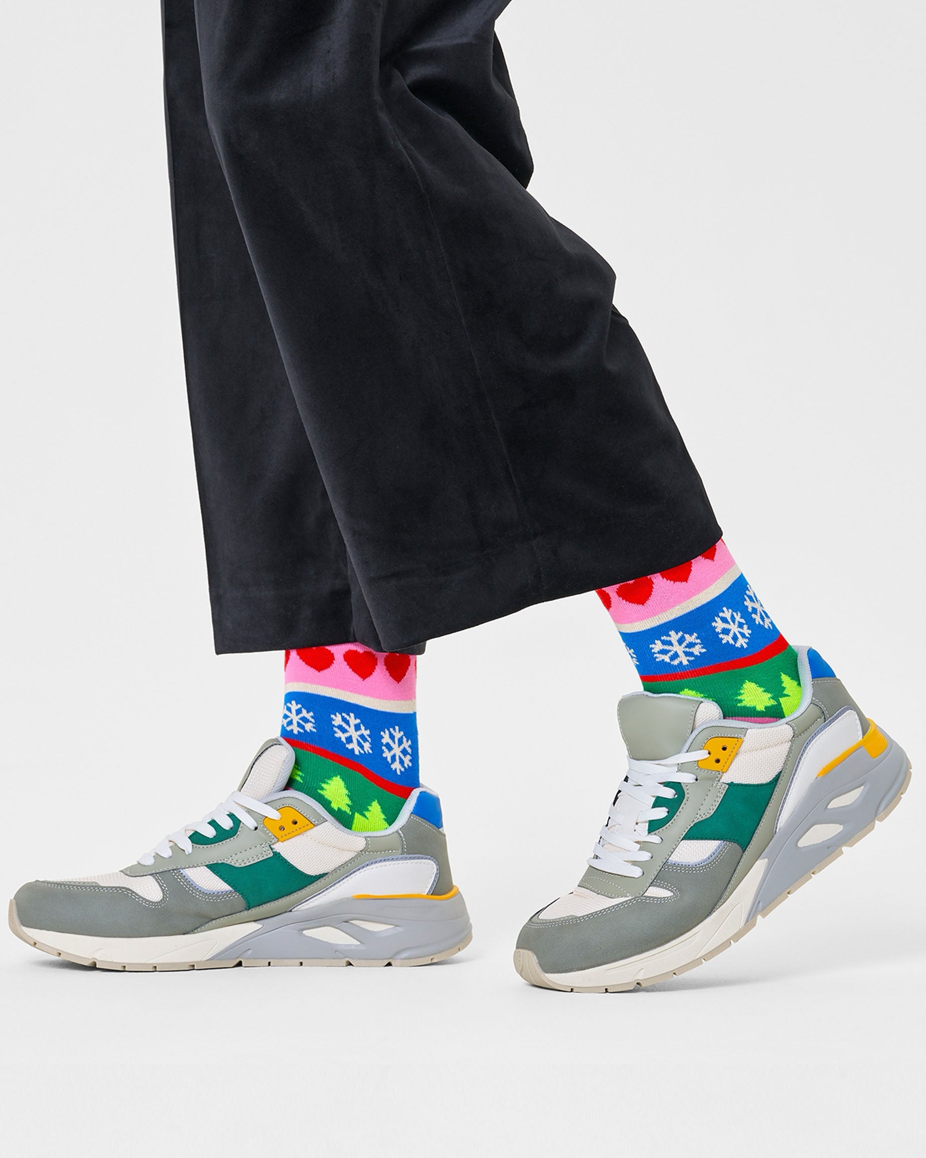 Happy Sock P000265 Christmas Stripe Sock - colourful novelty Xmas socks with snowflakes, reindeer, hearts and Xmas trees. Worn with navy velvet cropped pants and trainers.