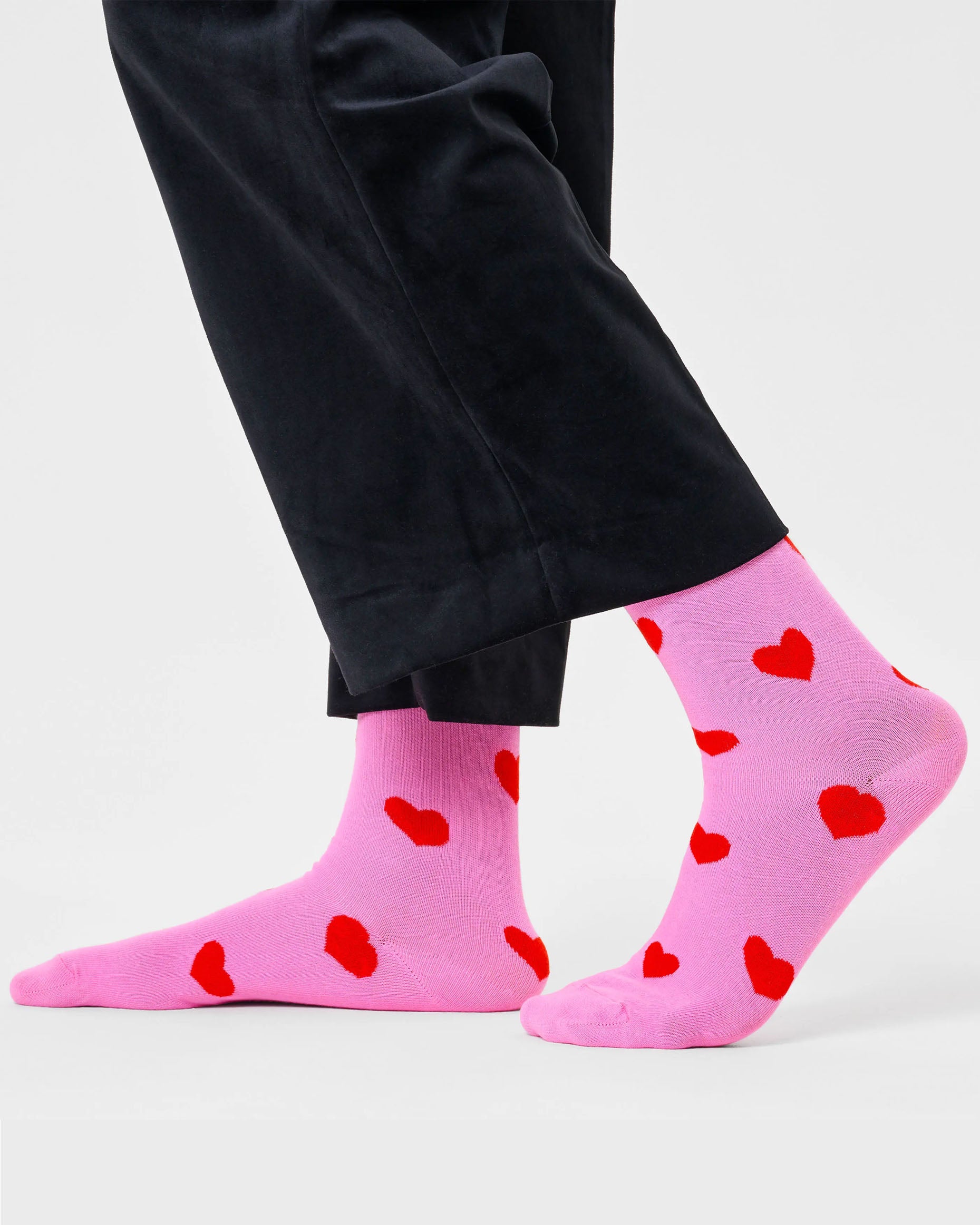 Happy Socks P000068 Heart Socks - Light pink cotton crew socks with all over red heart pattern worn with black velvet trousers. Perfect gift for Valentine's day