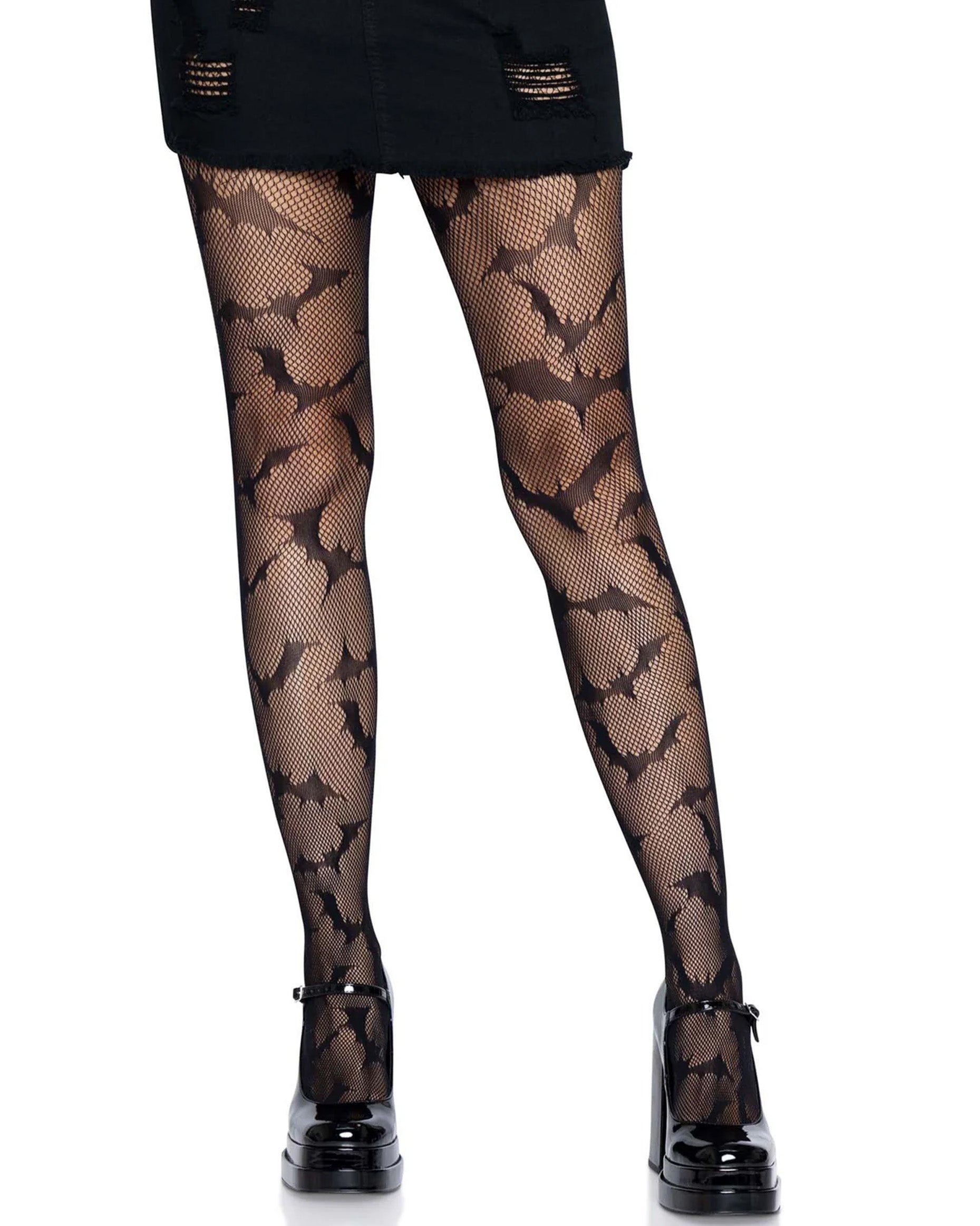 Black openwork fishnet tights with an all over flying bats pattern. Worn distressed black denim skirt and mary jane shoes.