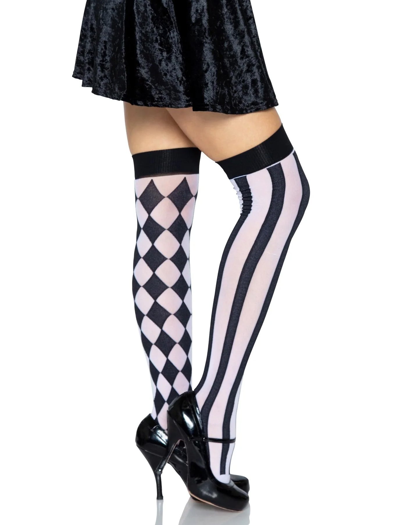Black and white opaque over-knee socks, one leg has a vertical stripe pattern and the other has a diamond pattern, worn with black velvet skirt and high heels.