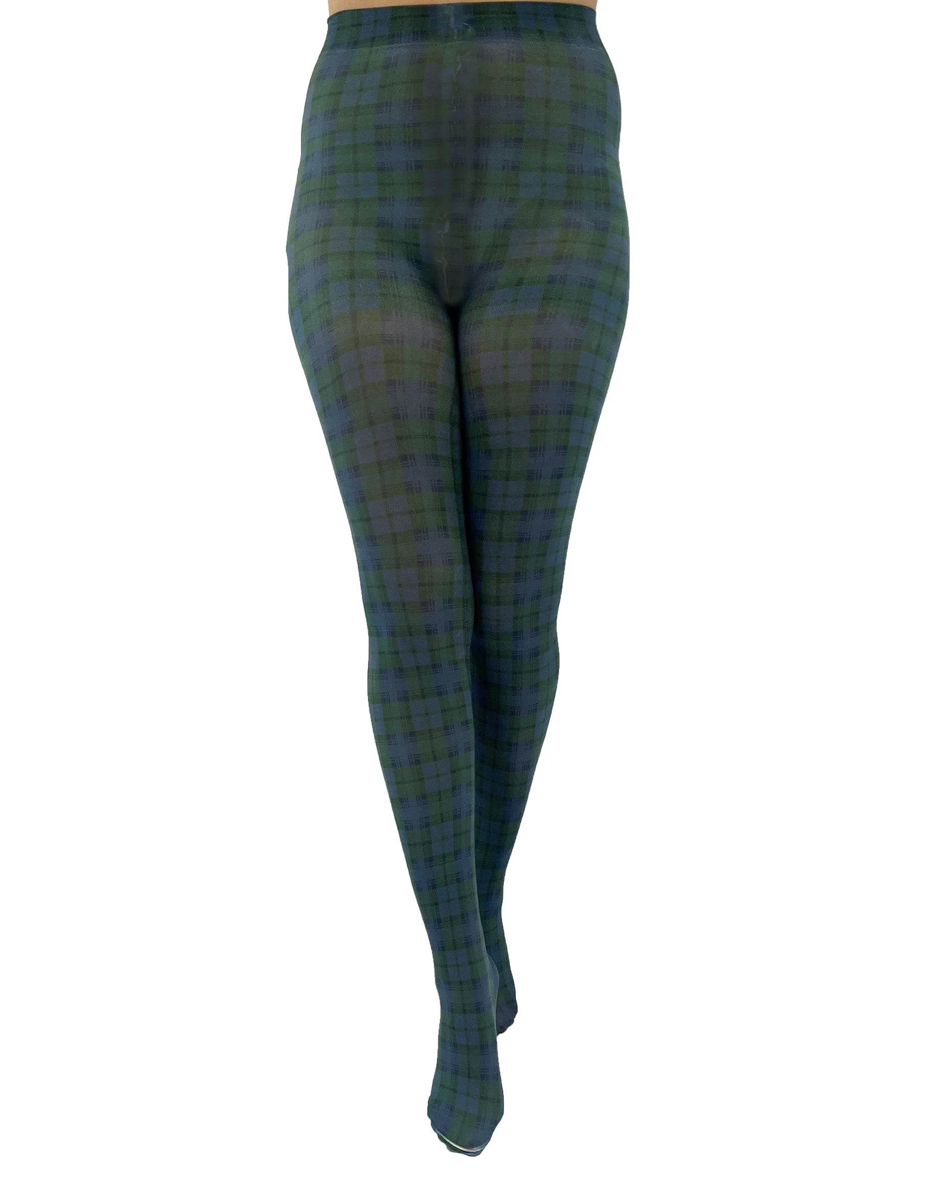 White opaque fashion tights with a green and navy tartan printed pattern. Front view.