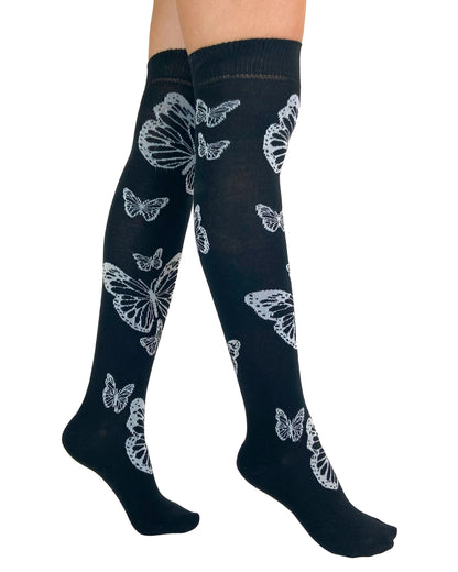Pamela Mann Butterfly Over-Knee Socks - Soft cotton mix black knitted over-knee socks with white butterfly motif pattern that flutters up the leg and deep elasticated cuff. Side view.