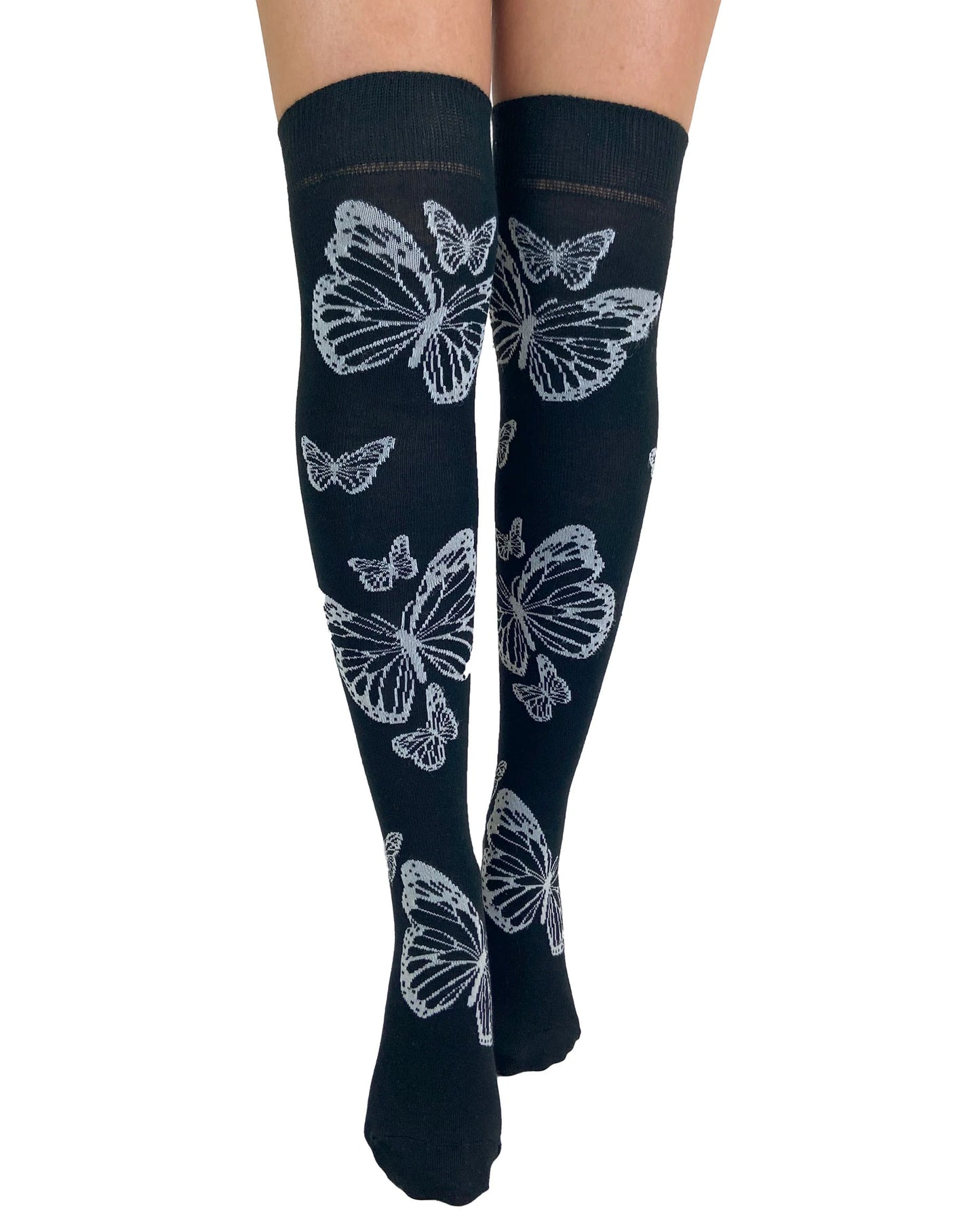 Soft cotton mix black knitted over-knee socks with white butterfly motif pattern that flutters up the leg and deep elasticated cuff. Front view.