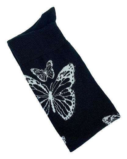 Soft cotton mix black knitted over-knee socks with white butterfly motif pattern that flutters up the leg and deep elasticated cuff. Folded view.
