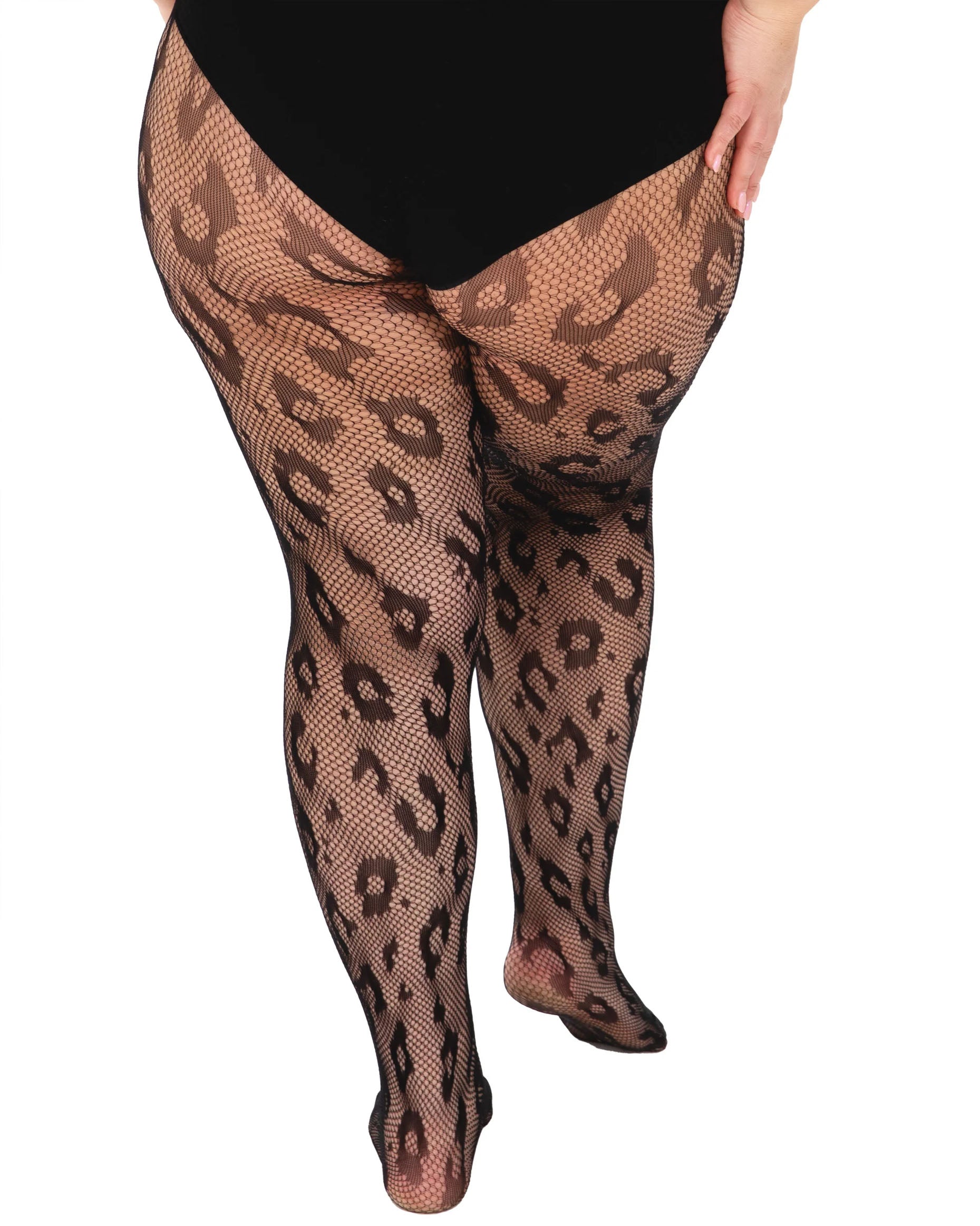 Leopard print fishnet tights worn by a plus size model wearing black panty briefs. Back view.