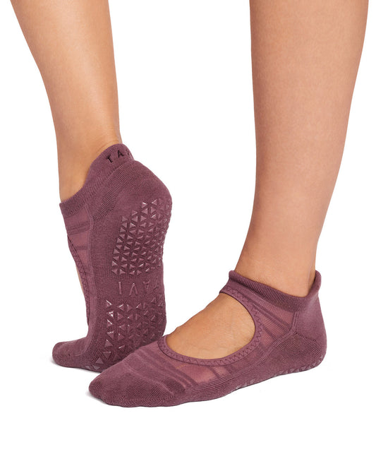 Purple yoga socks with textured sole worn by a person on a white background