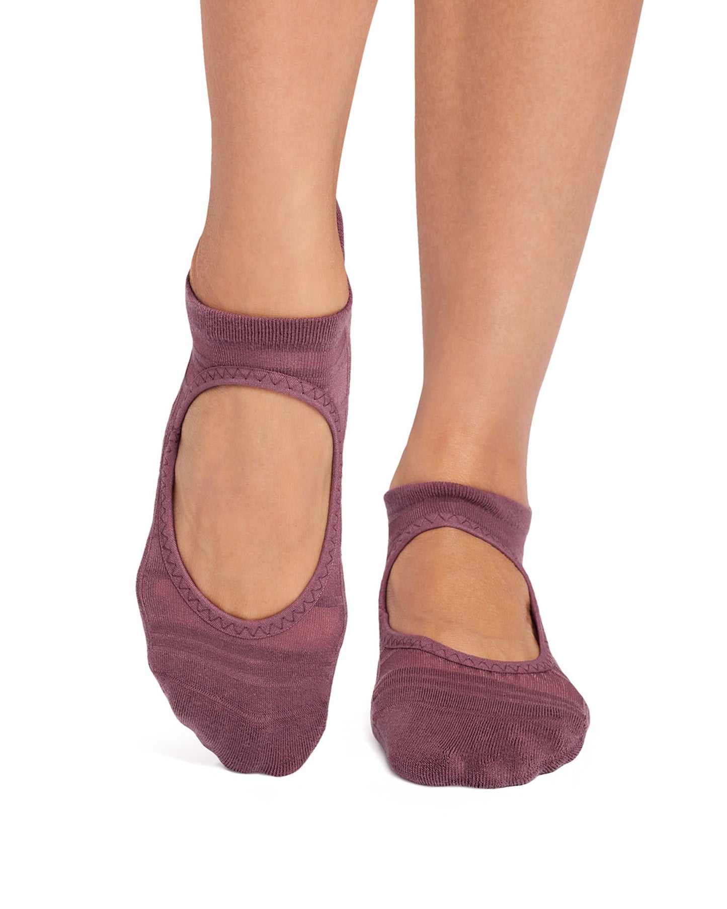 Purple ankle socks worn on a white background