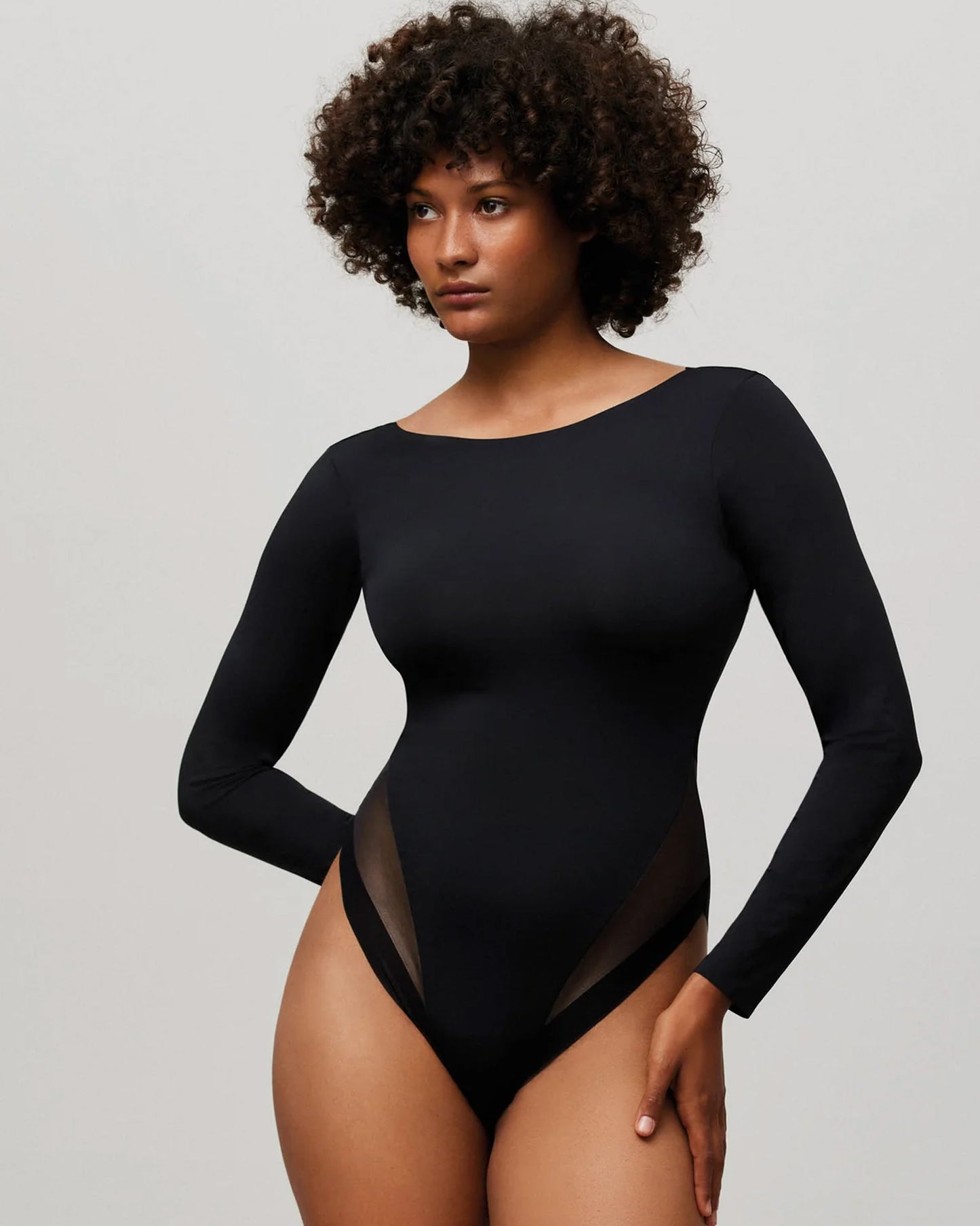 Ysabel Mora 10055 Scoop Back Body-Top - Black slinky and stretchy body-suit with a high neck line, low scooped back, sheer tulle panels around the leg and snap fastener closures.