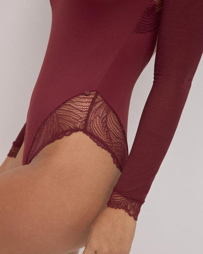 Maroon long-sleeve top with lace detailing on a plain background