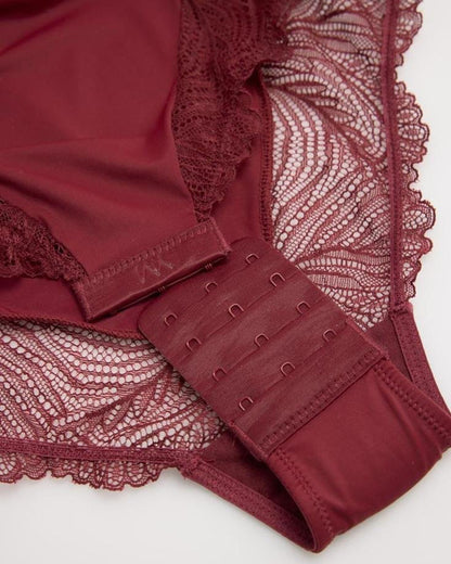 Close-up of a burgundy lace body-top hook and eye closures on a white background