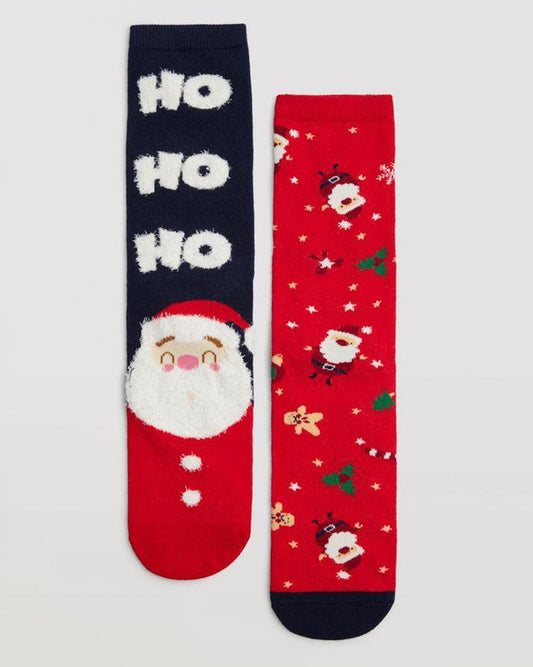 Ysabel Mora 12901 Santa Socks Gift Box 2 Pk - Pack of 2 pairs of Christmas cotton socks, one pair is red with Santas, ginger bread men, candy canes, holly and snow flakes pattern and the other is predominantly navy with an upside down Santa in a chimney on one sock and has an upright Santa with a fluffy beard and the text "ho ho ho".