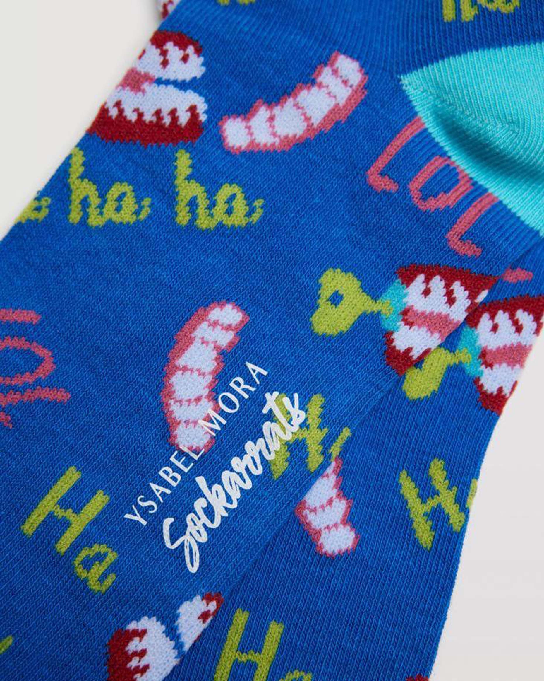 Ysabel Mora 12905 Joke Socks - Blue cotton socks with an all over pattern of wind up joke teeth, the text "LOL" and "ha ha ha" in red, pink, white and lime green, turquoise toe.