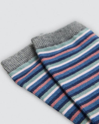 Pair of striped socks with gray, blue, pink, and green colors on a light gray background.