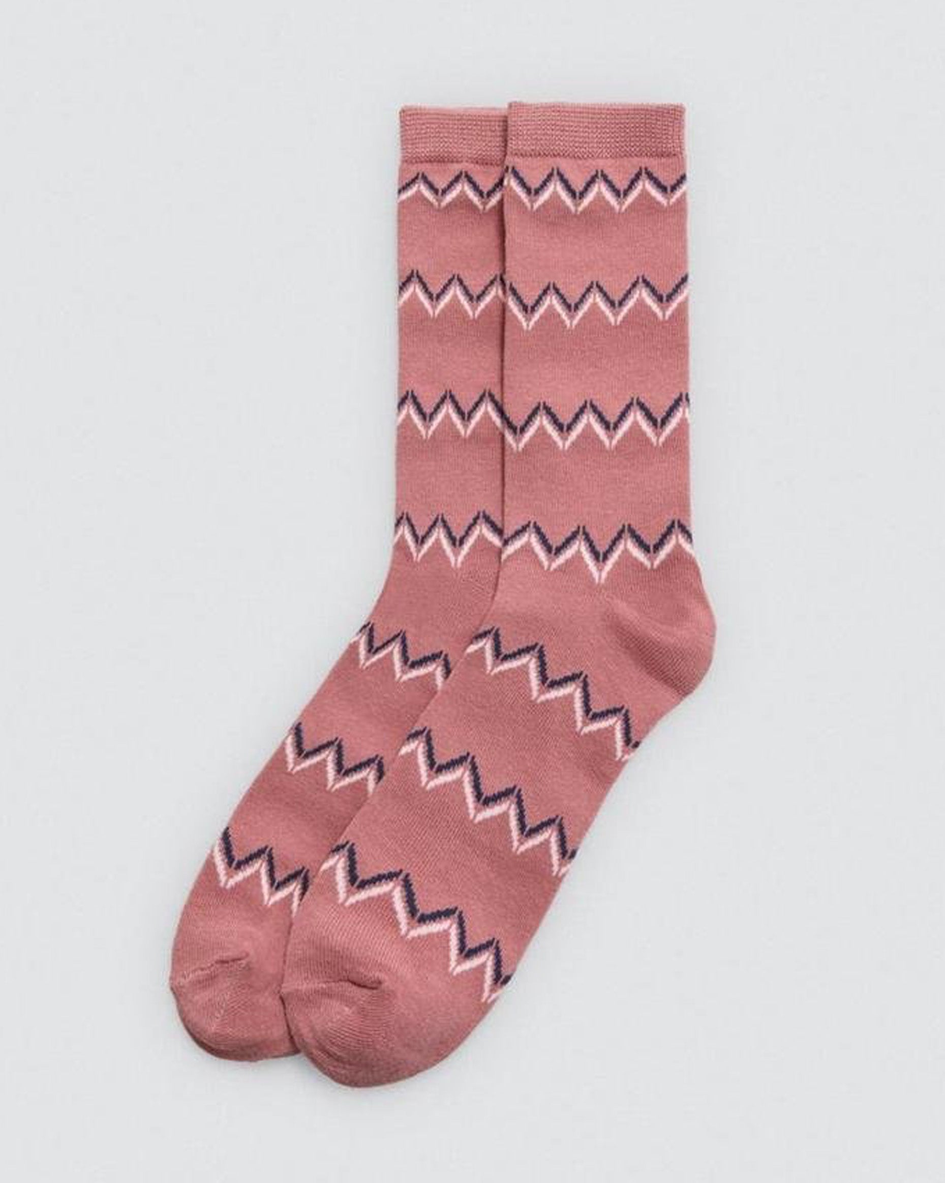 Pink sock with zigzag pattern on a light gray background