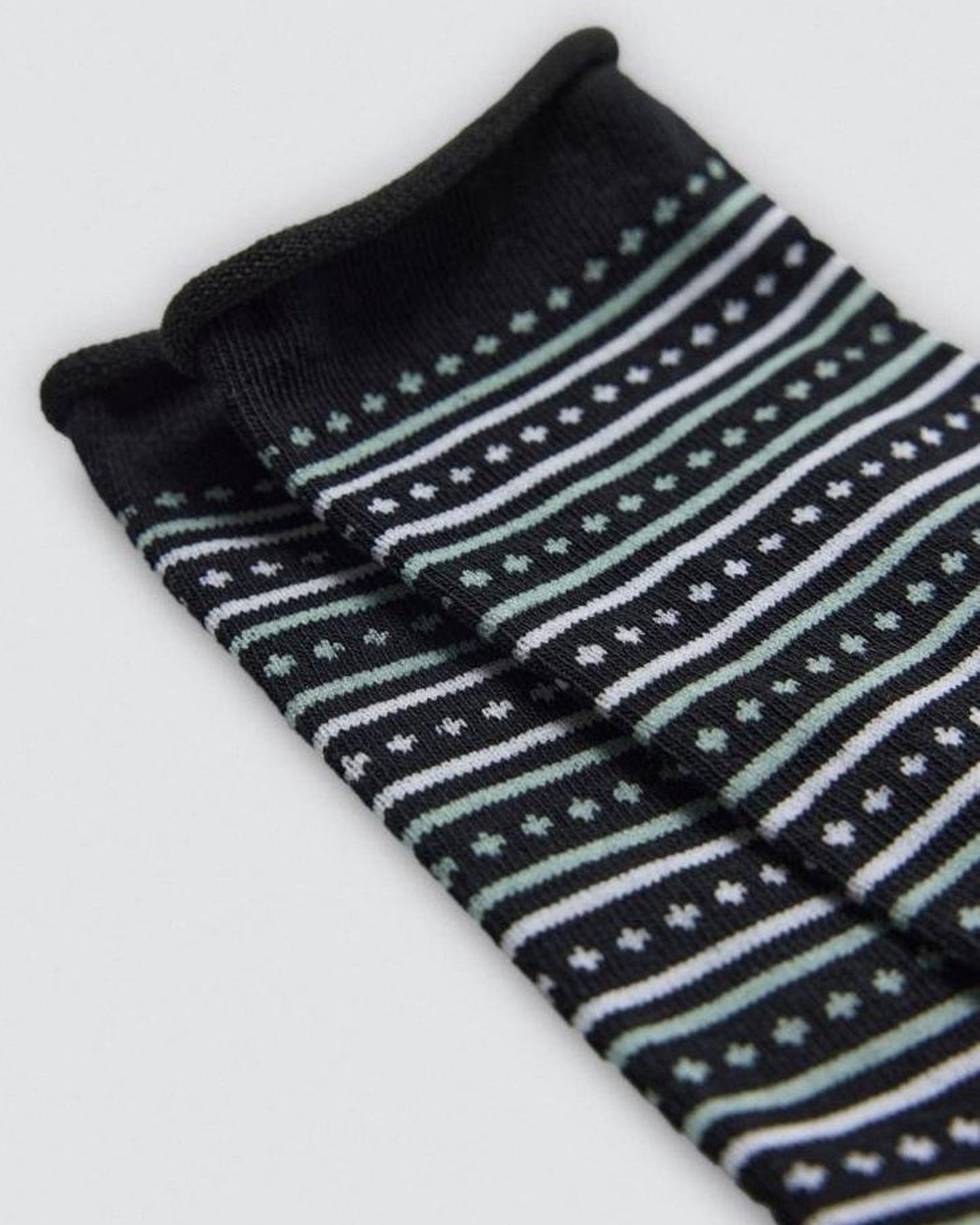 Pair of black socks with white and light blue star pattern on a white background