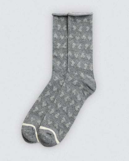 Grey sock with subtle linear pattern on a light gray background