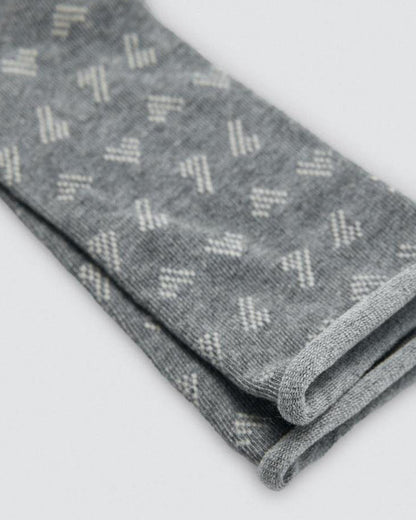 Folded gray fabric with a subtle linear pattern on a white background
